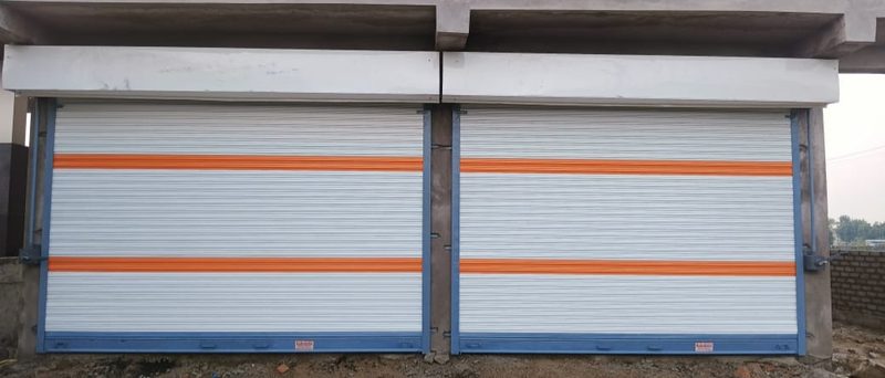 Twin gear rolling shutters with orange stripe, new construction site, Nagpur